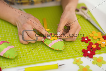 Closeup on young woman making easter decoration