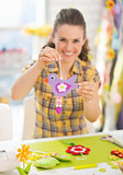 Closeup on happy young woman showing easter decoration