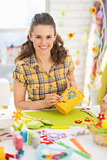 Portrait of happy young woman making easter basket in studio