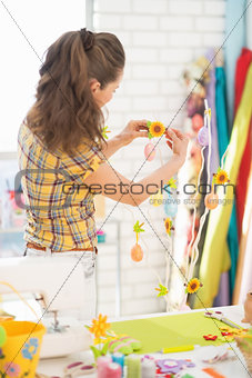 Young woman preparing for easter. rear view
