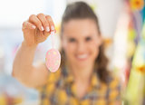 Closeup on young woman showing easter decorative egg
