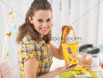 Happy young woman making easter basket