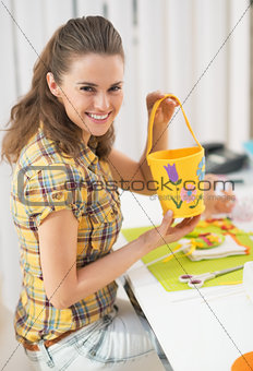 Happy young woman making easter basket