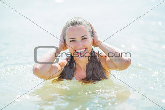Portrait of happy young woman in swimsuit at sea