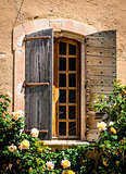 Detail of old vintage wooden window with wild roses