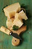 piece of natural parmesan cheese on a wooden board