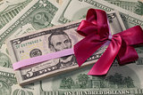 Pack of dollar bills with red bow