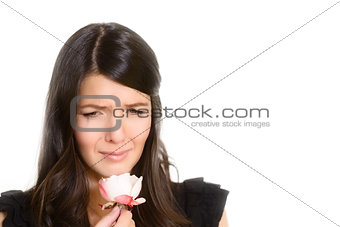 Sorrowful woman clutching a single rose