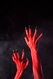 Horror red devil hands with black nails  