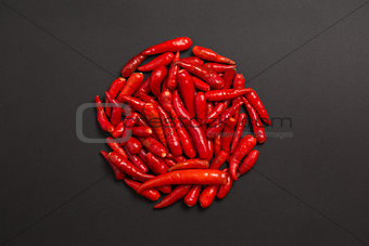 Circle made of non-stem red bird eye chili peppers 