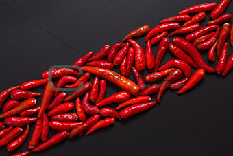 Row of non-stem red bird eye chili peppers 