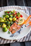 Fried salmon with lemon and brussels sprouts