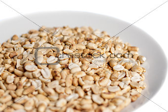 roasted peanuts in a plate on white background