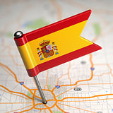 Spain Small Flag on a Map Background.