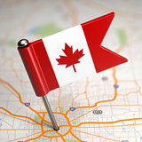 Canada Small Flag on a Map Background.