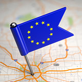 European Union Small Flag on a Map Background.