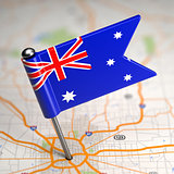 Australia Small Flag on a Map Background.