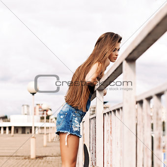 beautiful lady with long silky hair in denim short overalls