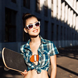 beautiful lady with skateboard in the city