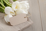 white tulips on wood table