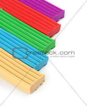 pieces of colored plasticine on a white background