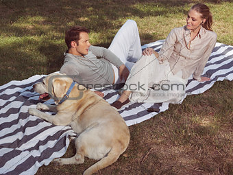 couple having rest with dog
