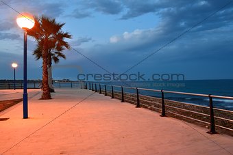 Stone beach promenade at sunset