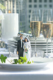 Close-up of figurine couple on dinner plate at reception