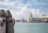 Rusty Chain on Pier Posts with Venice Church in Background