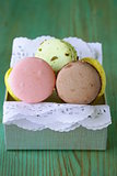 French multicolored macaroons cookies on a vintage wooden background