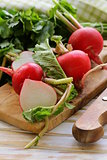 fresh ripe organic radishes on a wooden board
