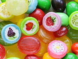colored caramel fruit candies on a white background