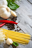 Garlic, pepper, basil, pasta and parmigiano background