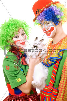 Couple of clowns with a white rabbit