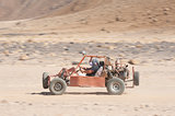 Desert buggy racing across ground