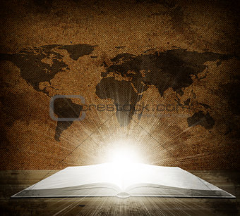 Over an open book is a map of the earth