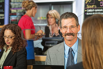 Businessman Sitting in Cafe