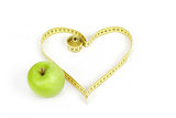 green apple with a measuring tape and heart symbol isolated