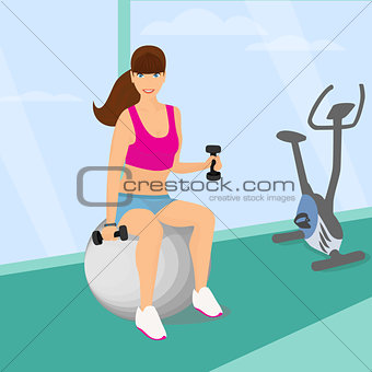 woman exercising with two dumbbell weights sitting on the fitness ball in the gym