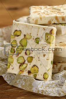 white nougat with different nuts on a wooden table