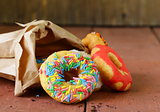 donuts with colorful glaze on the wooden background