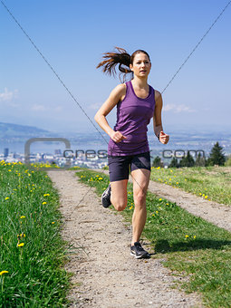 Young fit woman running in spring