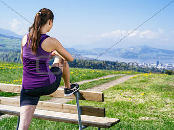 Woman stretching her legs in the park