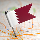 Qatar Small Flag on a Map Background.