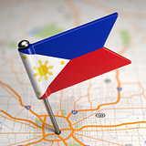 Philippines Small Flag on a Map Background.