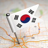 South Korea Small Flag on a Map Background.