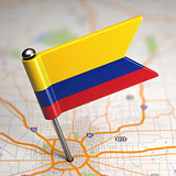 Colombia Small Flag on a Map Background.