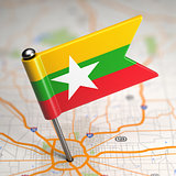 Myanmar Small Flag on a Map Background.