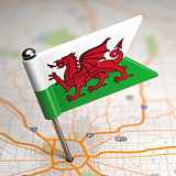 Wales  Small Flag on a Map Background.