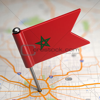 Morocco Small Flag on a Map Background.